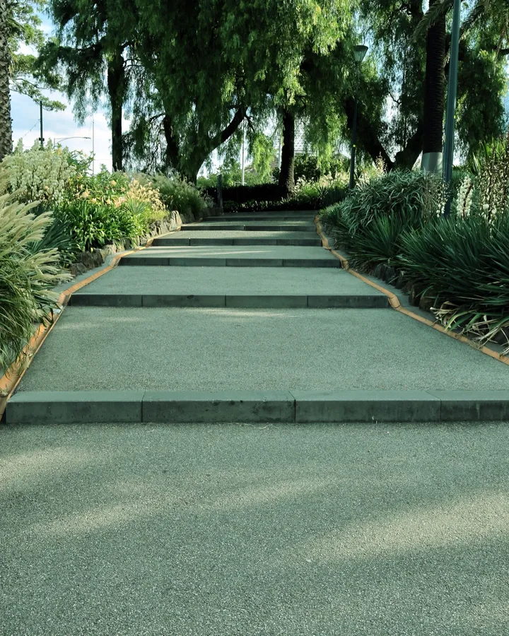 Wide stone steps with dense plantings on both sides, used as general hardscape atmosphere.